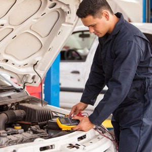 An auto electrical technician in Darwin working on a vehicle