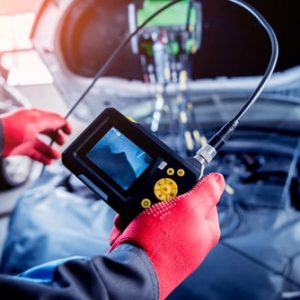 An auto electrician running engine diagnostics on a vehicle in the Darwin workshop